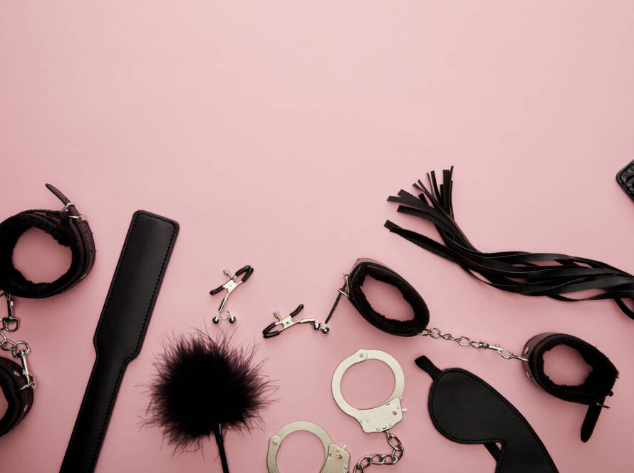 top view of black sex toys on pink background